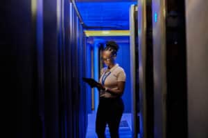 Woman holding an ipad in a data center