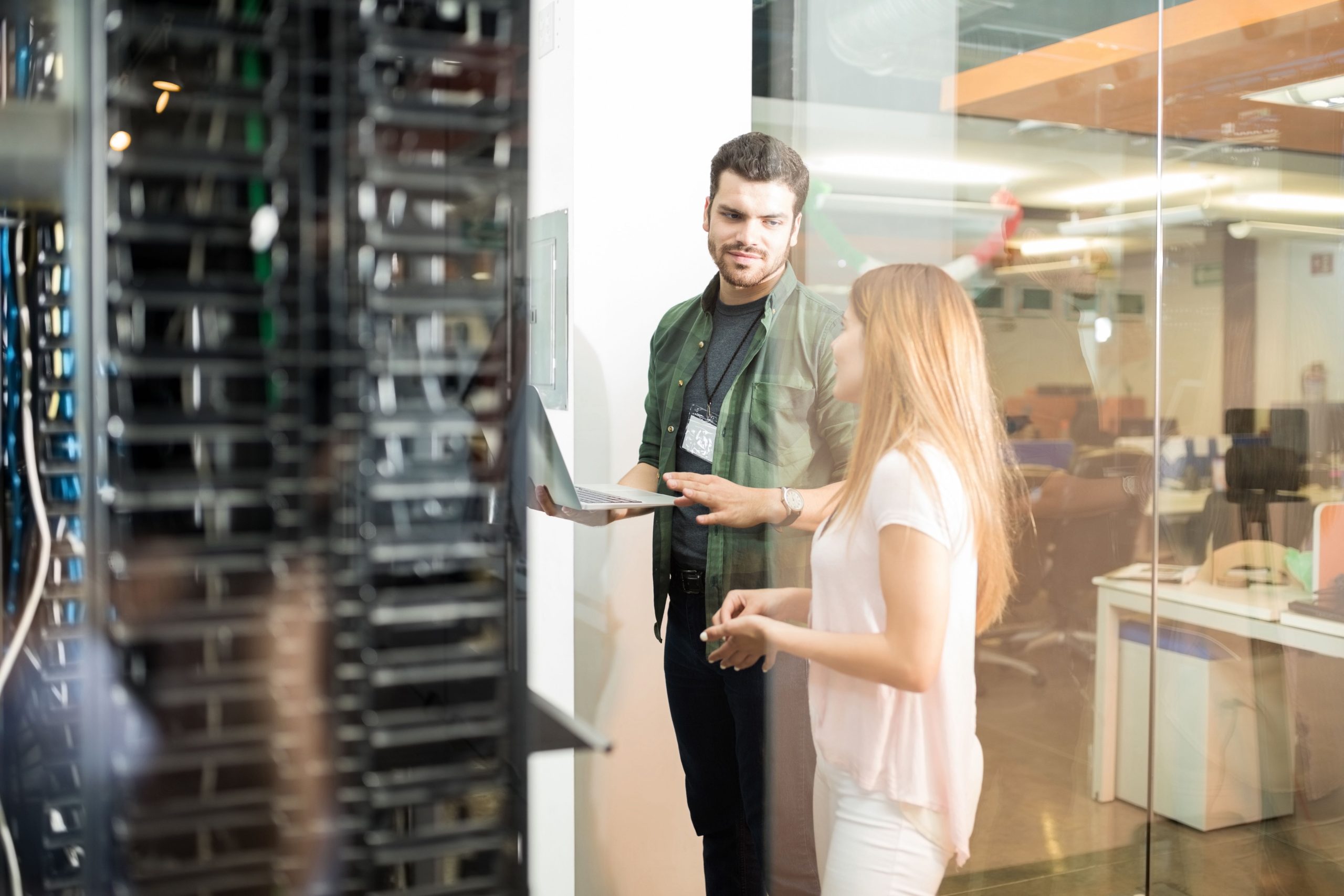 two employees evaluating a server room in a data center